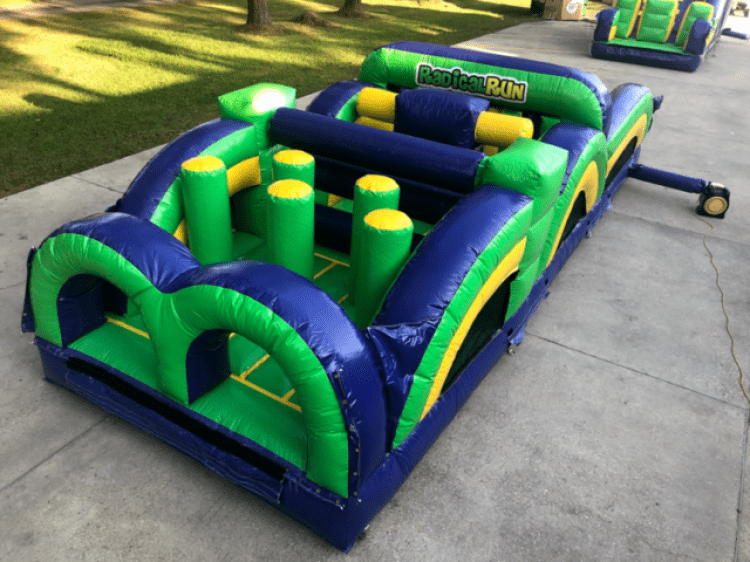 Large inflatable obstacle course rental set up outdoors for a church event