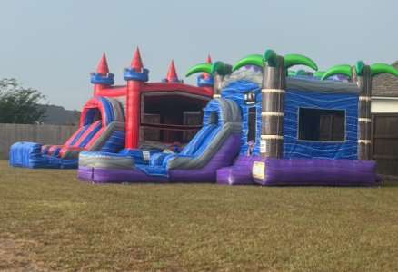 Pink and purple castle combo bounce house with slide on grass for a school event rental