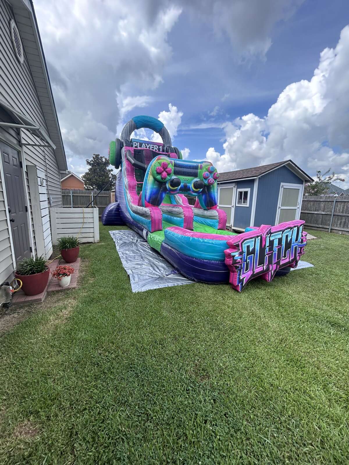 Glitch gamer water slide rental set up in an Acadiana backyard for a full day of fun