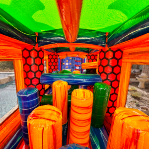 Inside an inflatable obstacle course rental in Acadiana, showing the padded tunnels and climbing obstacles that stay firm only while the blowers keep running